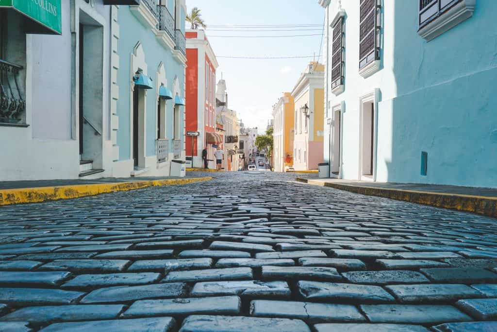 Cobble stone street with very colorful houses lining the street in old san juan puerto rico
