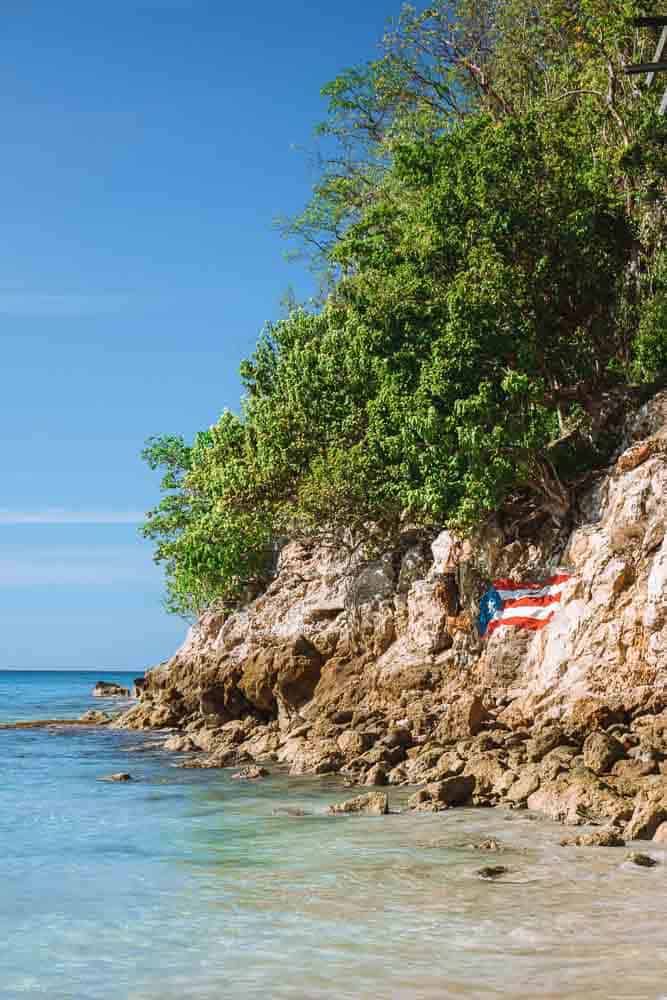 puerto rican flag painted on rock at playa crash boat
