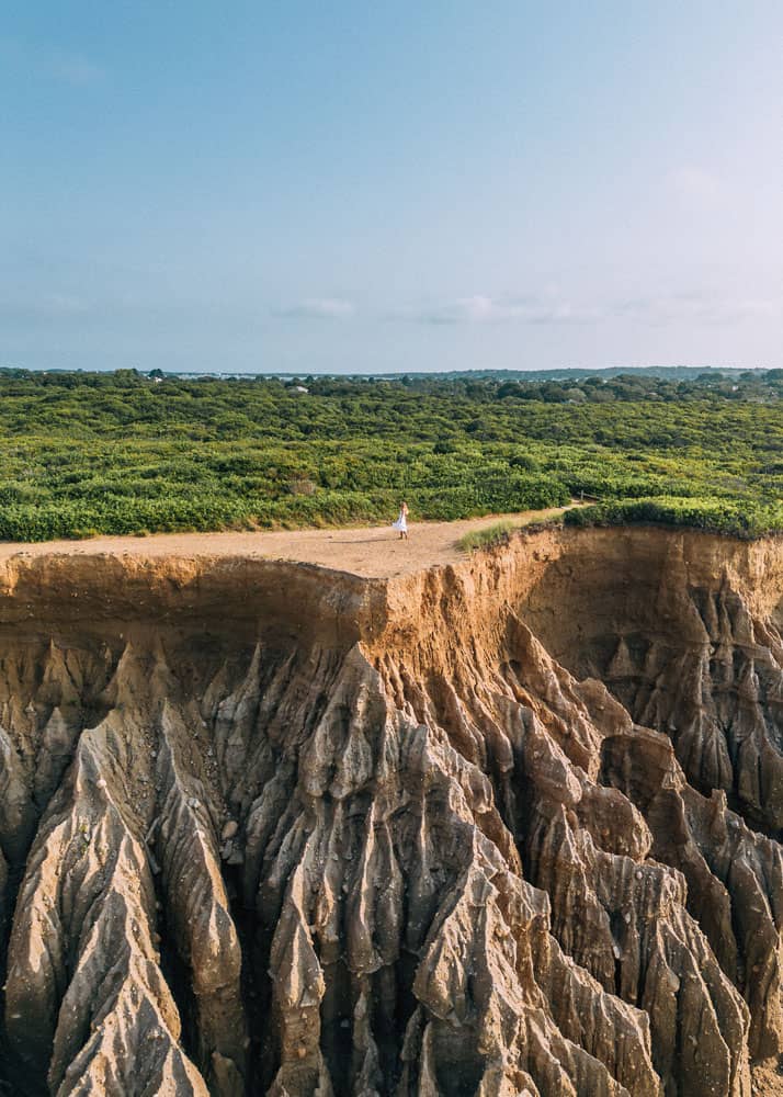 woman on cliffs at one of the best hikes in montauk