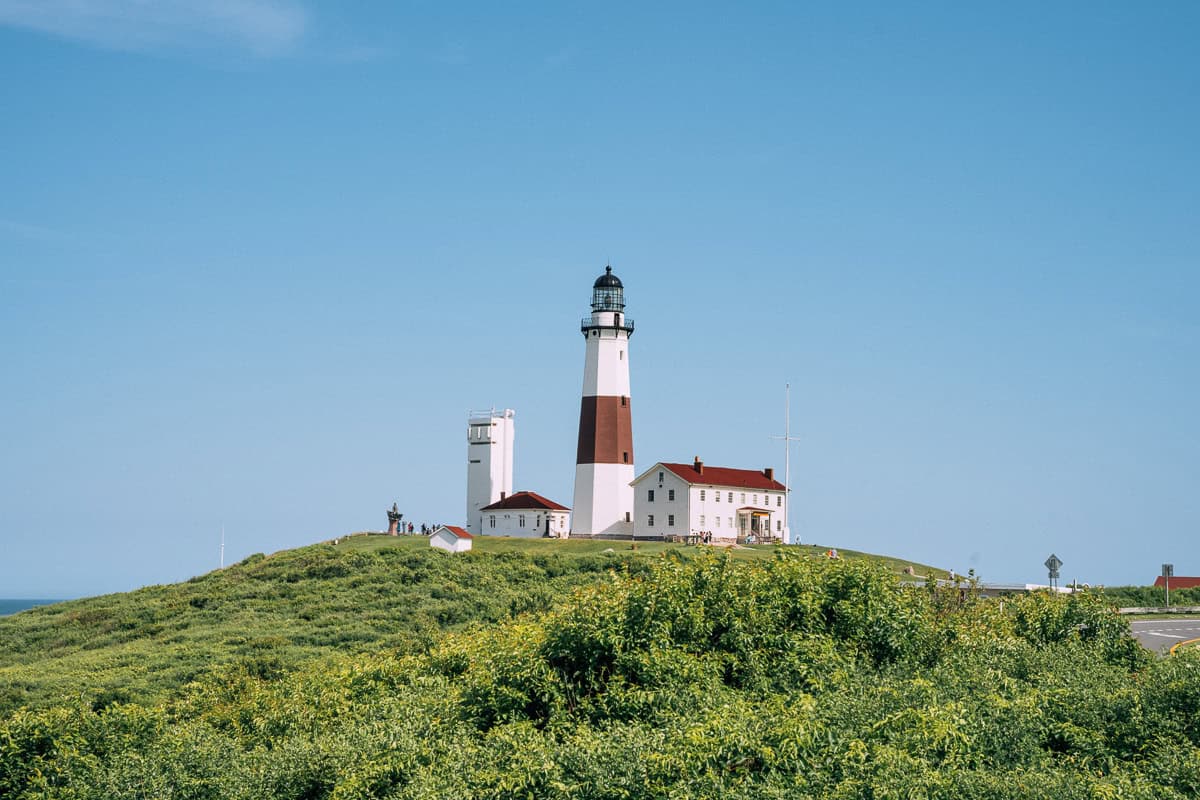 Montauk Lighthouse on a bright sunny day with greenery in the foreground